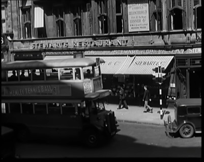 Exterior of Stewards Restaurant and London Traffic. Sign on the Side of a Bus Reads..., 1931. Creator: British Pathe Ltd.
