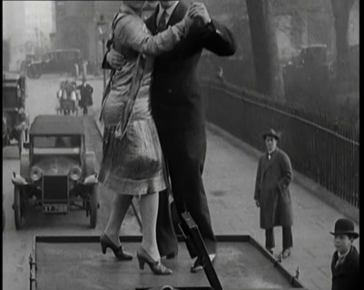 A Couple Dancing the Charleston on the Top of a Car Driving Down a London Street, 1926. Creator: British Pathe Ltd.