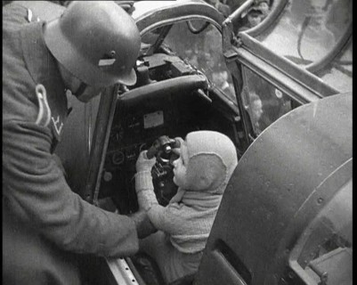 A Young Boy Sitting in the Cockpit of a Fighter Plane, 1930s. Creator: British Pathe Ltd.