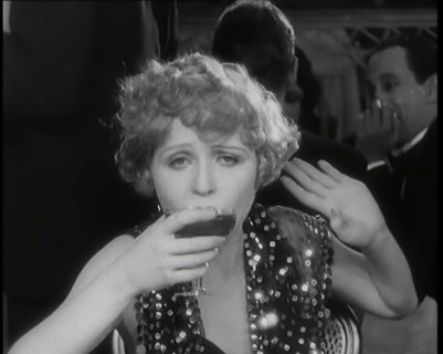 Scene from the Film 'Champagne': Betty Balfour in a Nightclub Drinking Champagne, 1920s. Creator: British Pathe Ltd.