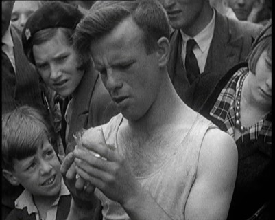 A Man Eating a Glass as the Crowd Behind Him Winces, 1921. Creator: British Pathe Ltd.