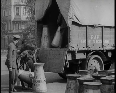 Milk Churns Being Loaded Onto a Lorry by Male Soldiers, 1926. Creator: British Pathe Ltd.