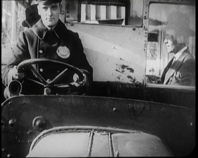 Male Bus Driver Sitting in the Cabin of a Bus, 1922. Creator: British Pathe Ltd.