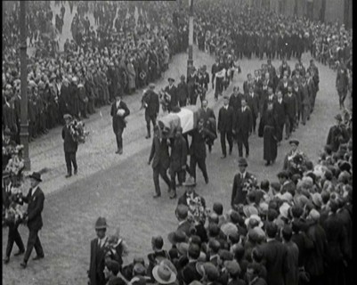 Huge Crowds Watching the Funeral Procession of Terence MacSwiney. His Coffin Is Draped..., 1920. Creator: British Pathe Ltd.