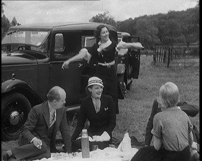 Male and Female Civilians Having a Picnic Beside a Car, 1931. Creator: British Pathe Ltd.