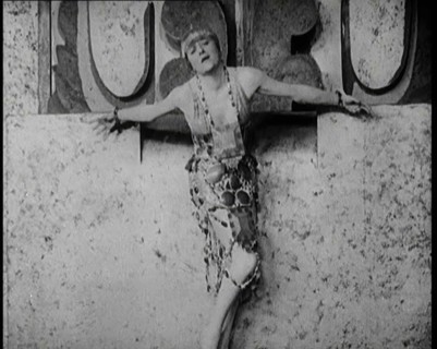 A Female Actor Chained to a Wall for a Performance, She Is Wearing a Glamorous Dress, 1922. Creator: British Pathe Ltd.