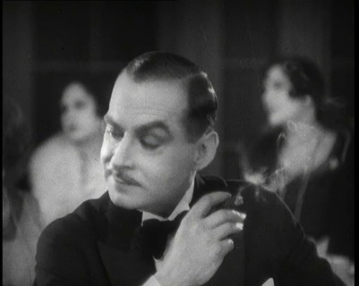 Scene from the Film 'Champagne': a Male Actor in a Nightclub Smoking a Cigarette, 1920s. Creator: British Pathe Ltd.