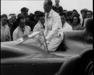 Malcolm Campbell Entering a Car While a Crowd Watches, 1933. Creator: British Pathe Ltd.