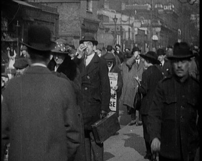 Men Wearing 'Pathe Gazette' Sandwich Boards Handing Out Pieces of Polaroid Film to Crowds..., 1921. Creator: British Pathe Ltd.