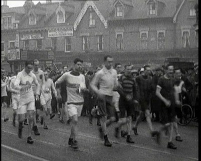 Crowds Watching a Men's Walking Race in the Street, 1920. Creator: British Pathe Ltd.