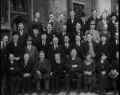 Prime Minister Ramsay MacDonald Sitting on a Chair Smoking Whilst Surrounded by Members of..., 1924. Creator: British Pathe Ltd.