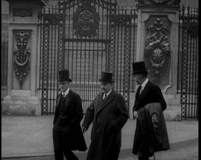 Three British Male Members of Parliament Walking Away from Buckingham Palace, 1924. Creator: British Pathe Ltd.