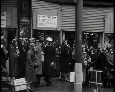 Men and Women Waiting on a Pavement Wearing Gas Masks, 1939. Creator: British Pathe Ltd.