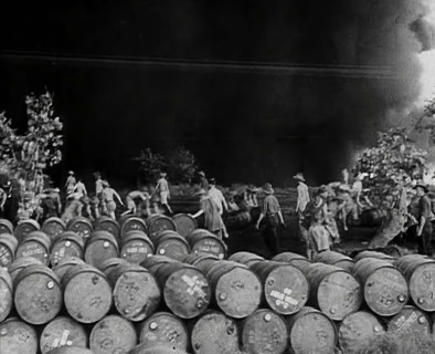 Commonwealth Troops Walking Through a Flaming Supply Dump, 1941. Creator: British Pathe Ltd.