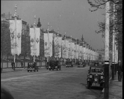 Cars Driving Down the Mall Which Is Decorated By Flags For the Coronation of King George VI, 1937. Creator: British Pathe Ltd.