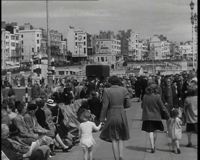 British Holidaymakers Walking Along the Promenade or Sitting on Deckchairs at Brighton..., 1938. Creator: British Pathe Ltd.