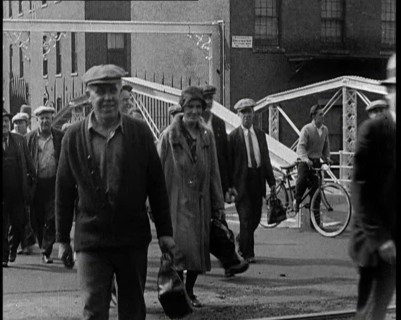 Workers Leaving Factory Through Factory Gates Which Are Closed After Them, 1932. Creator: British Pathe Ltd.
