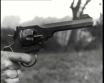 Scene from the Feature Film 'The White Sheik'. A Pistol Being Held By a Man With His Finger...,1920s Creator: British Pathe Ltd.