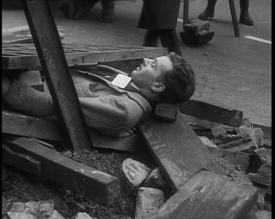 British People Acting Out Bomb attacks and Crashed German Planes, Lying Under Rubble, 1940. Creator: British Pathe Ltd.