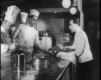 A Galley With Kitchen Staff Cooking and Waiters With Dishes on Board the 'Strength Through..., 1939. Creator: British Pathe Ltd.