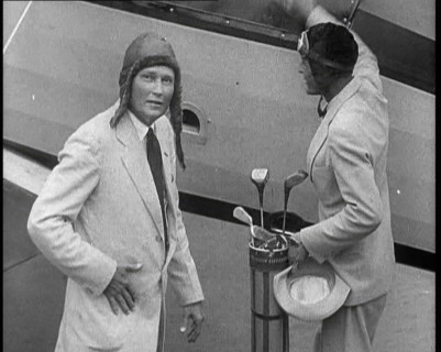 Two Golfers With Gold Clubs Enter a Gyrocopter, 1932. Creator: British Pathe Ltd.