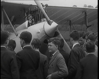 A Group of Young Male British Civilians Admiring an Airplane On an Airfield, 1920s. Creator: British Pathe Ltd.