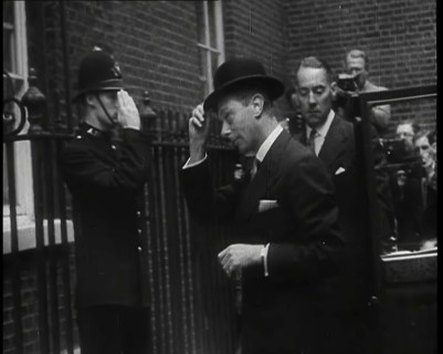 A Male British Police Officer Saluting King George VI, the British Monarch who is Exiting..., 1939. Creator: British Pathe Ltd.