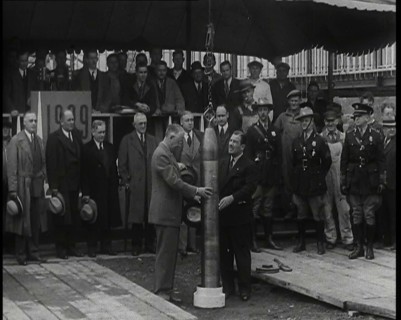 Two British Men Guiding a Time Capsule Being Lowered in the Ground With Various Civilians..., 1938. Creator: British Pathe Ltd.