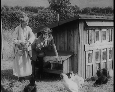Stage Star Syndey Fairbrother Collecting Hen Eggs on Her Farm, 1920s. Creator: British Pathe Ltd.