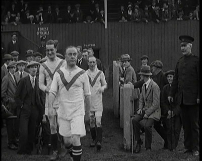 The Comedian George Robey Running Out Onto a Football Pitch in Front of a Large Crowd, 1920s. Creator: British Pathe Ltd.