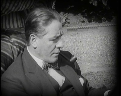 Matheson Lang Relaxing in a Deck Chair Smoking a Pipe, 1920s. Creator: British Pathe Ltd.