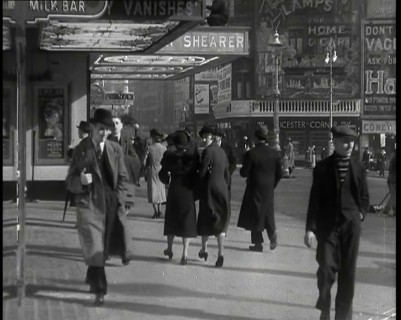 Men and Women Walking Through Leicester Square With the Leicester Corner Restaurant..., 1939. Creator: British Pathe Ltd.