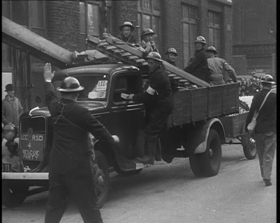 British Air Raid Wardens Arriving at a Phoney Air Raid Scene, 1940. Creator: British Pathe Ltd.
