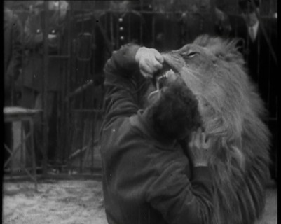 Man Sticking his Head in a Lion’s Mouth, 1930s. Creator: British Pathe Ltd.