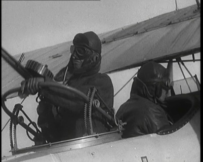 Male British Pilots On Board a Plane And Mounting a Machine Gun, 1920s. Creator: British Pathe Ltd.