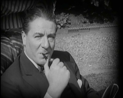 Matheson Lang Relaxing in a Deck Chair Smoking a Pipe, 1920s. Creator: British Pathe Ltd.