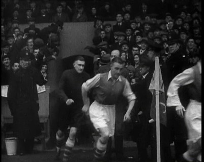 Crowds Watching Football Players Running onto the Football Pitch, 1930s. Creator: British Pathe Ltd.