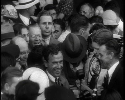 Jim Mollison Walking Surrounded by a Large Crowd, 1930s. Creator: British Pathe Ltd.