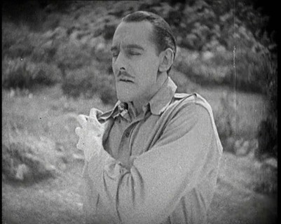 Scene from the Feature Film 'The White Sheik'. An Actor Portraying a Male Soldier Grabbing..., 1920s Creator: British Pathe Ltd.