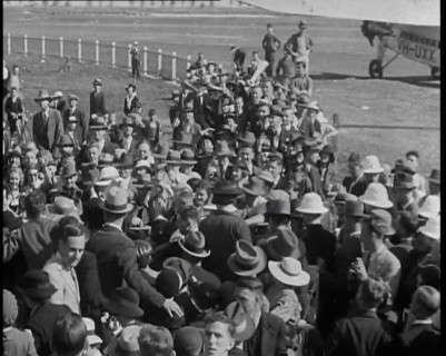 Jean Batten Walking Through a Crowd, 1930s. Creator: British Pathe Ltd.