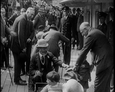 King George V of the United Kingdom Sitting On a Model Train With a Crowd of People Watching, 1924. Creator: British Pathe Ltd.