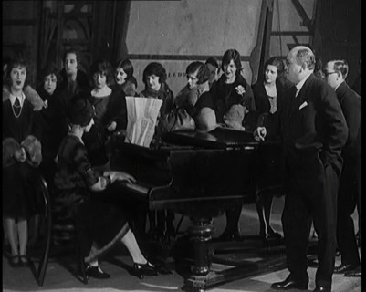 Female Civilian Singing Scales Badly Whilst Other Female Civilian is Playing the Piano in..., 1920s. Creator: British Pathe Ltd.