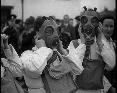 A Close up of Three Female Civil Defence Volunteers in White Boiler Suits Putting on Gas..., 1938. Creator: British Pathe Ltd.