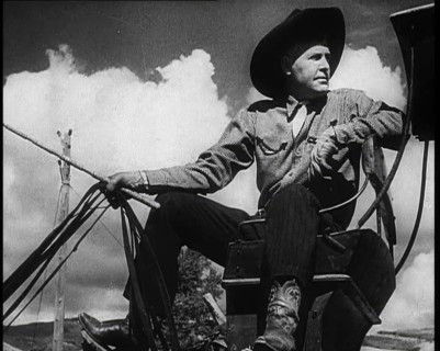 Male Civilian With a Cowboy Hat Sitting On a Coach Waiting For Passengers, 1932. Creator: British Pathe Ltd.