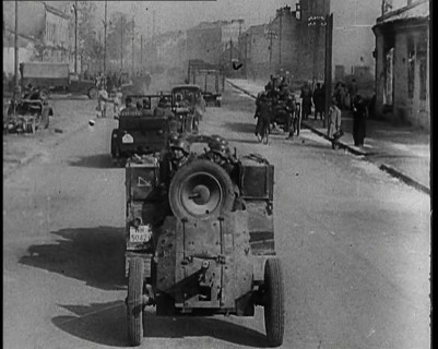 German Army Vehicles With Male Soldiers in Them Driving Down a Street in Warsaw Past..., 1939. Creator: British Pathe Ltd.