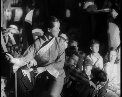 A Female Civilian in a Traditional Robe Dancing With Sabres As People Watch Her Performanc..., 1932. Creator: British Pathe Ltd.