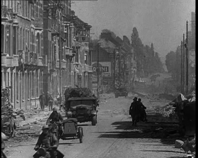 British Expeditionary Force Retreating Through Belgian Town on Vehicles, 1940. Creator: British Pathe Ltd.
