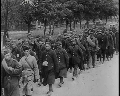 Male Polish Soldiers Walking Along an Unpaved Road Beside a Line of Trees With Fences Beyond, 1939. Creator: British Pathe Ltd.