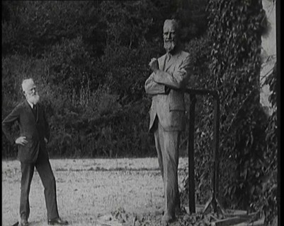 Playwright George Bernard Shaw Standing Next To a Statue of Himself, 1920s. Creator: British Pathe Ltd.