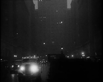 A Car Driving Towards the Camera With Very Bright Head Lights On the Streets of New York..., 1932. Creator: British Pathe Ltd.